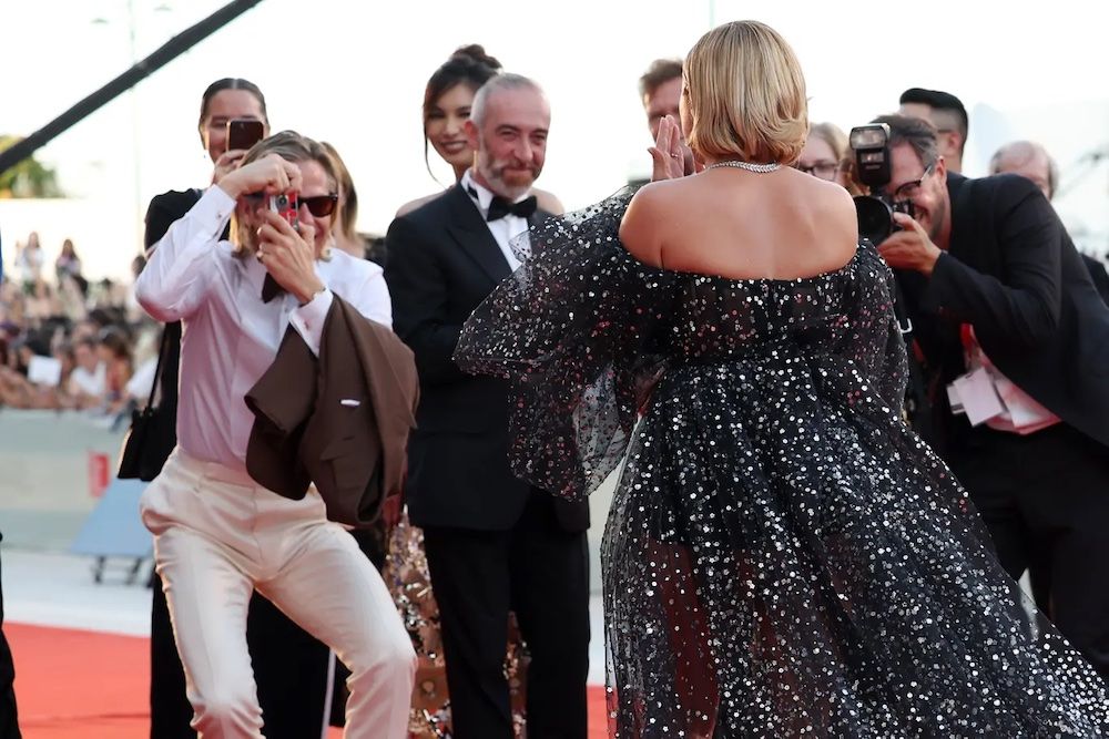 Chris Pine, the second best of Hollywood Chris and perfectly content to be so, taking an analogue snap shot of co-star Florence Pugh resplendent on the red carpet at the Venice Film Festival.