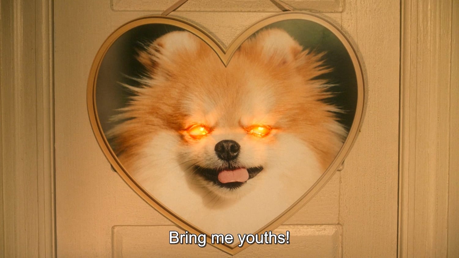 A heart-shaped poster of a pomeranian with glowing red eyes from Fantasmas. Subtitle reads: "Bring me youths!"